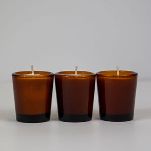 soy votive candle in amber glass jars
